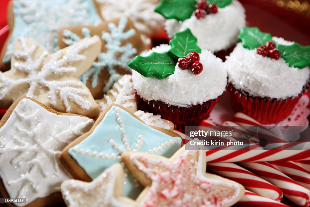 A plate of Christmas cookies, cupcakes and candy canes