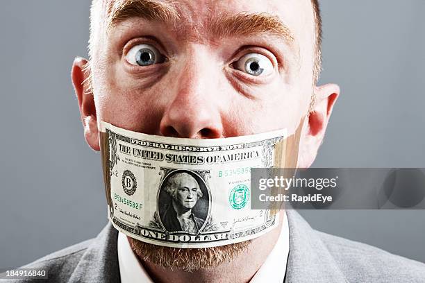 wide eyed businessman is shocked by dollar bill gag - rea001 stock pictures, royalty-free photos & images