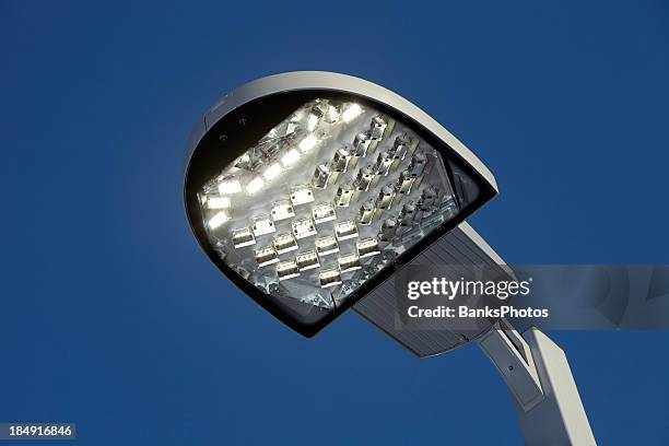 illuminated led streetlight against a clear blue sky - led stock pictures, royalty-free photos & images