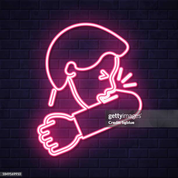 stockillustraties, clipart, cartoons en iconen met cough or sneeze into elbow. glowing neon icon on brick wall background - niezen