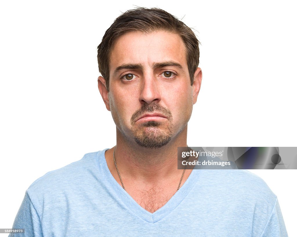 Sad man in a light blue T-shirt on a white background