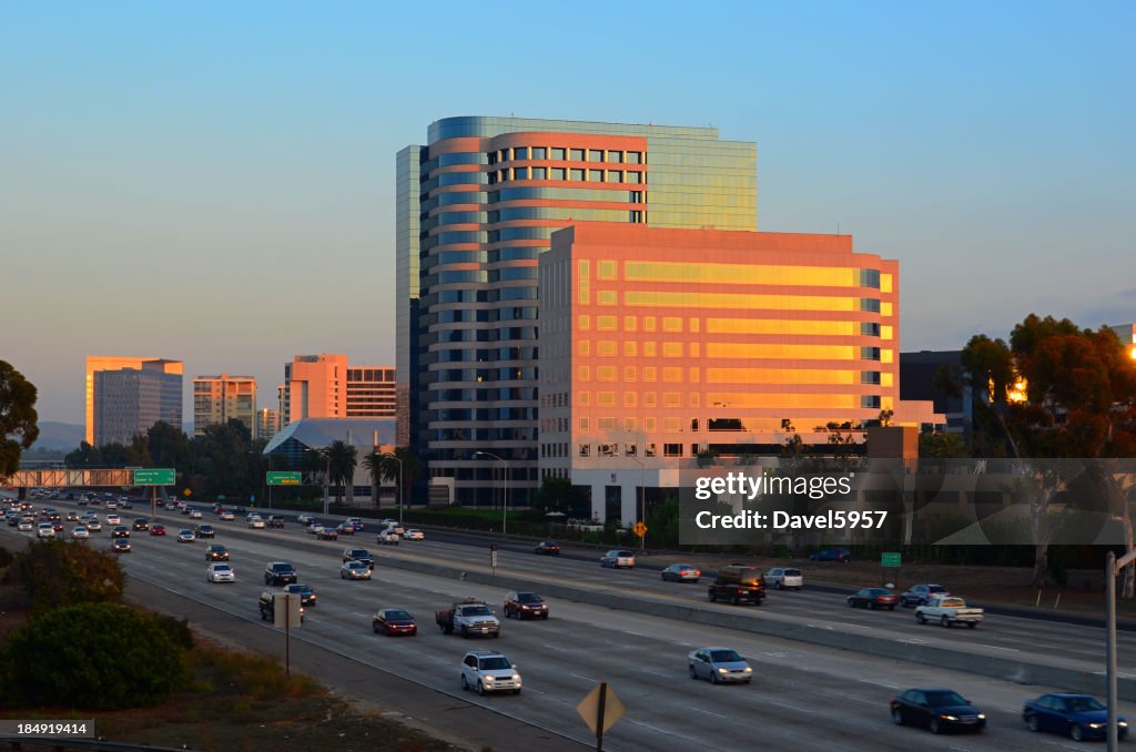 Irvine city skyline and freeway at sunset