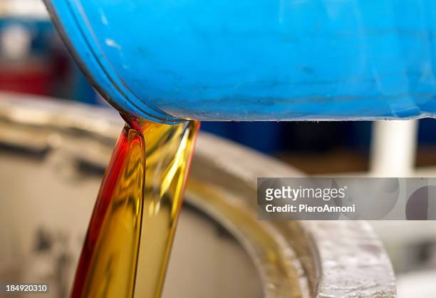pouring oil - drum container stock pictures, royalty-free photos & images