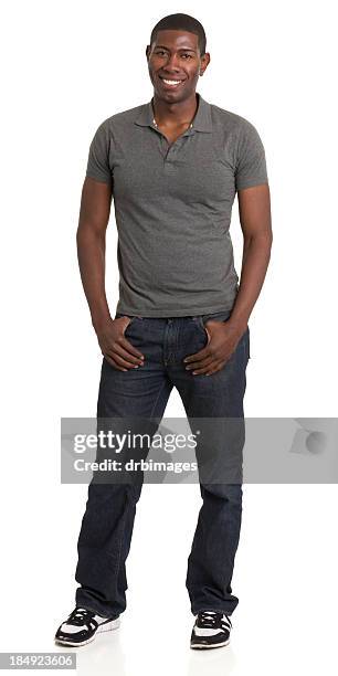 smiling standing young man portrait - gray jeans stockfoto's en -beelden