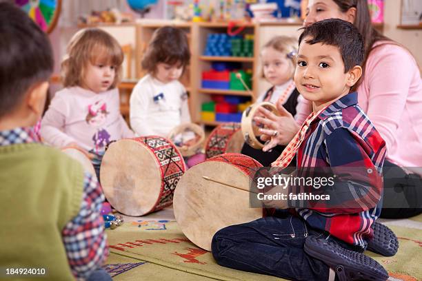 Preschoolers Using Instruments Children Playing Musical Instruments Photos and Premium High Res ...
