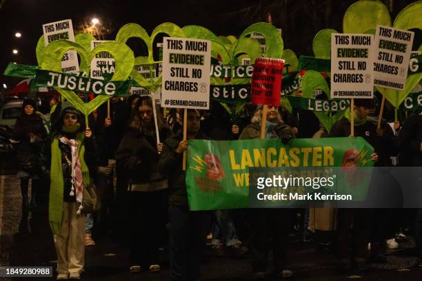 Members of the Grenfell community and supporters take part in the Grenfell Silent Walk around West Kensington on 14th December 2023 in London, United...