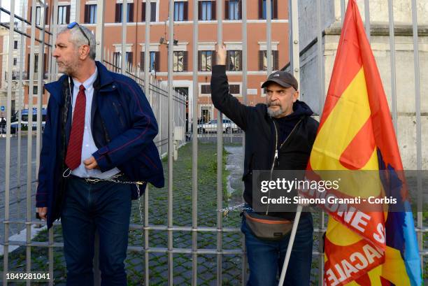 Guido Lutrario, leader of the USB union and a trade unionist worker of the ATAC, hain themselves in front of Palazzo Chigi, as a sign of protest...