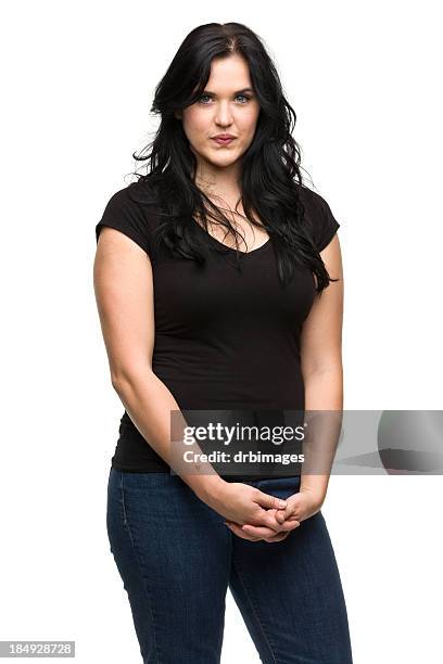 serious young woman standing - white trousers stockfoto's en -beelden