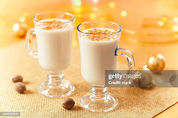 two large glasses of eggnog served beautifully - nutmeg stock pictures, royalty-free photos & images