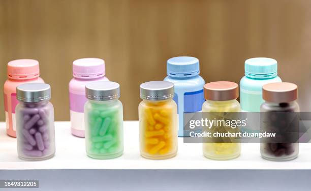 various pills and capsules, vitamins, omega 3 fish oil, and dietary supplements in bottle - heart pill ストックフォトと画像