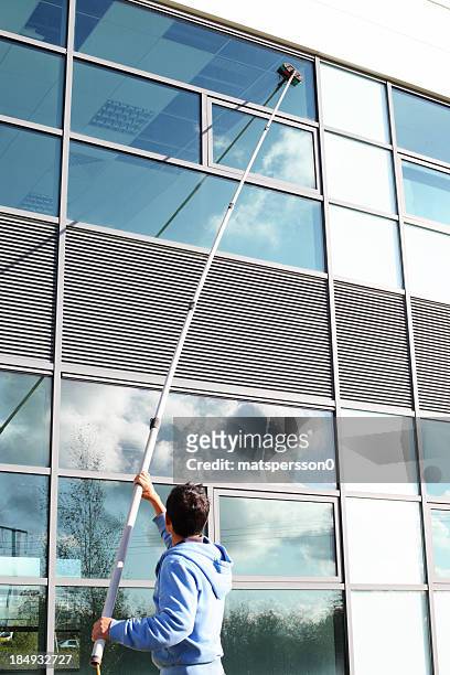 window cleaner using the water fed pole system - washing windows stock pictures, royalty-free photos & images