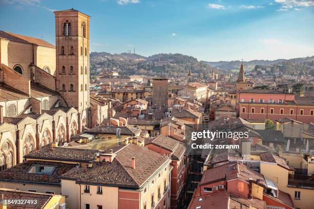 residential houses and buildings surrounding basilica di san petronio with bell tower in bologna, italy - bologna italy stock pictures, royalty-free photos & images