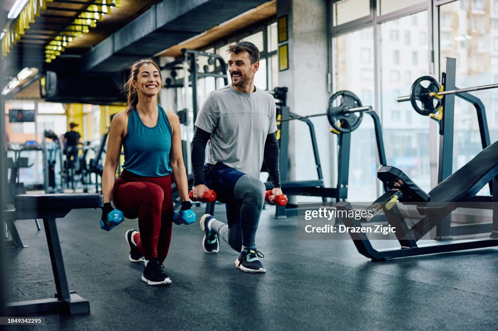 Happy While Exercise Happy Athletic Couple Exercising With Hand Weights In Lunge Position In ...