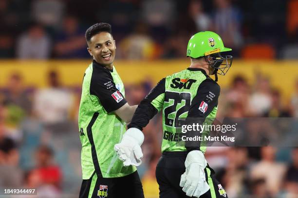 Tanveer Sangha of the Thunder celebrates with team mates after taking the wicket of Matt Renshaw of the Heat during the BBL match between Sydney...