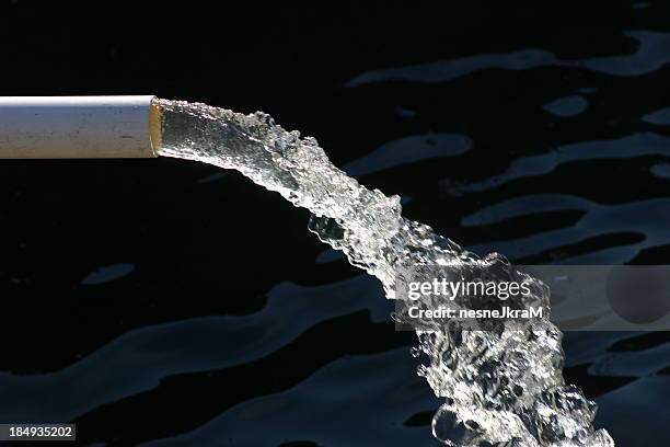 close-up of water pipe with pouring water - conduit pipe stock pictures, royalty-free photos & images