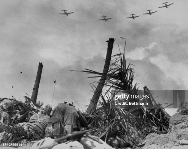 Marines army soldiers take cover during a battle in Roi-Namur, Marshall Islands, 16th February 1944.