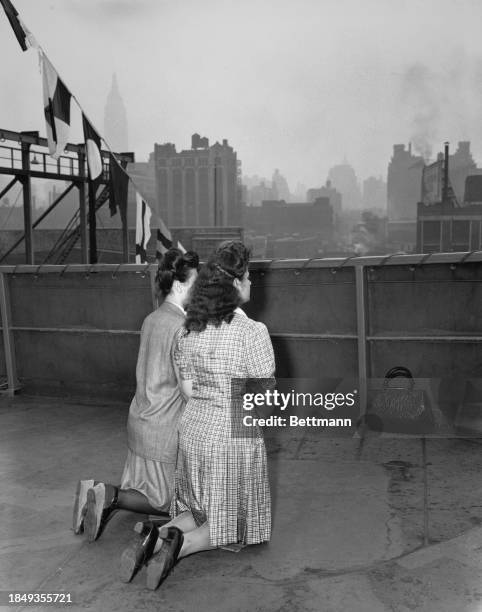 Leah Krys and Belier Kurant kneeling in prayers on the dock of SS Marine Flasher upon their arrival in New York, US, 20th May 1946.