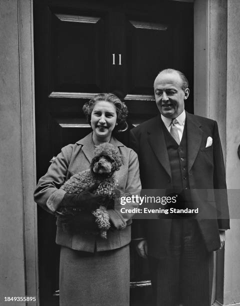 Chancellor of the Exchequer Peter Thorneycroft with his wife Carla who is holding a poodle dog outside No 11 Downing Street, London, April 26th 1957.