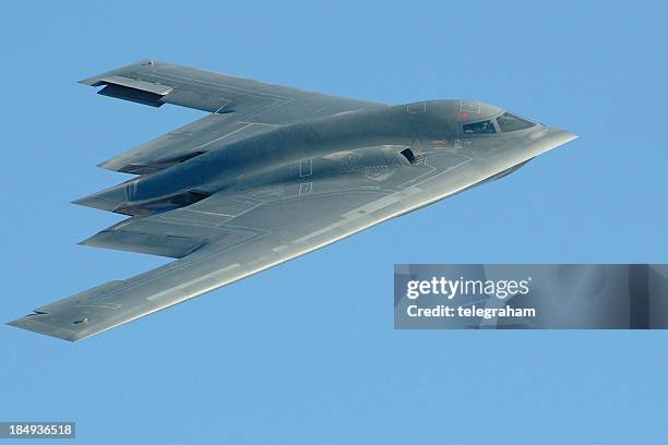 close-up photo of a b-2 stealth bomber in flight - bomber plane stock pictures, royalty-free photos & images