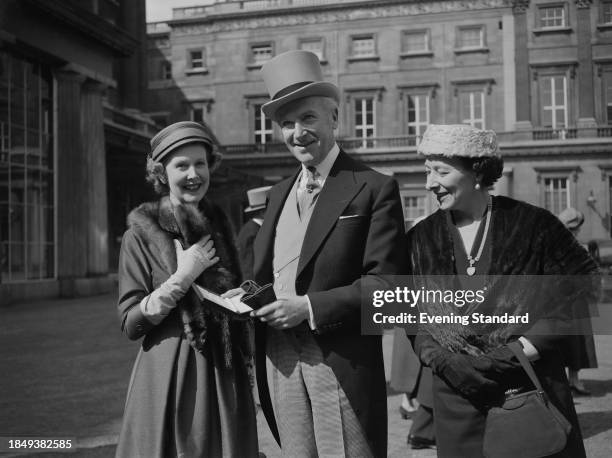 British photographer Cecil Beaton posing outside Buckingham Palace after being made a CBE at an investiture ceremony, London, March 26th 1957. He is...