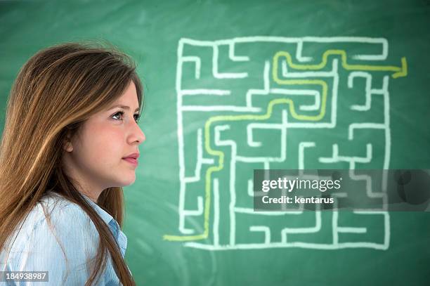 close-up of girl finding exit way of labyrinth - kentarus stock pictures, royalty-free photos & images