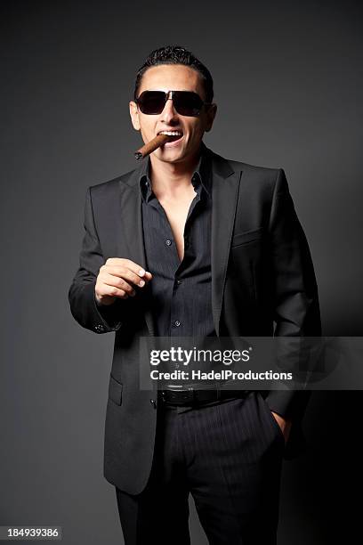 businessman in black suit with a cigar - black suit sunglasses stock pictures, royalty-free photos & images