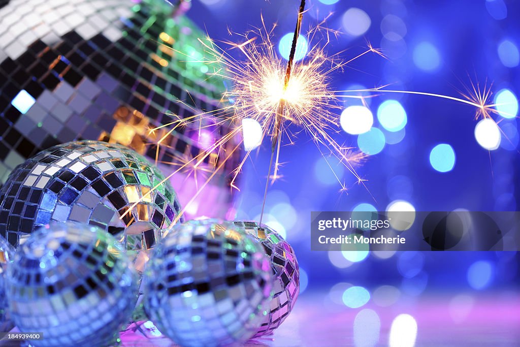 Party decoration with disco balls and fire sparkler