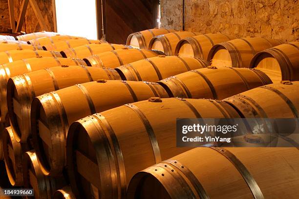 oak wine barrel rows in winery cellar, napa valley, california - cellar stock pictures, royalty-free photos & images