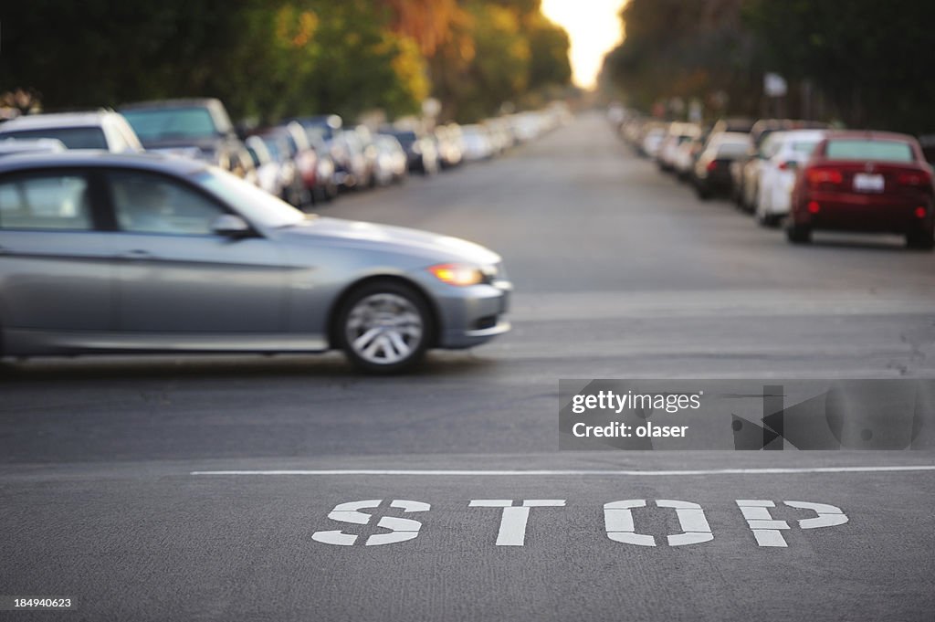 Road junction, stop word, motion blurred car