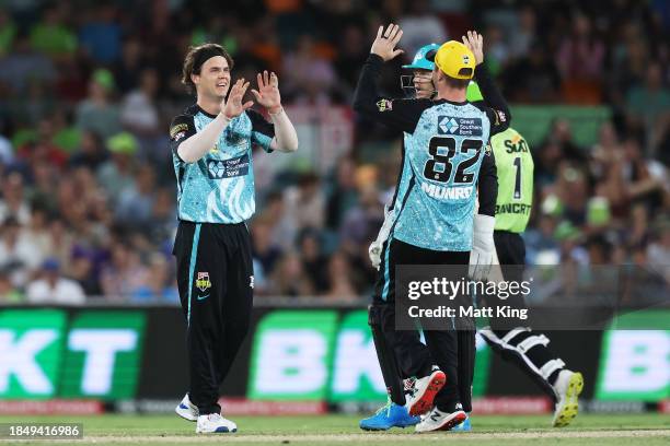 Mitch Swepson of the Heat celebrates with wicketkeeper Sam Billings after taking the wicket of Cameron Bancroft of the Thunder during the BBL match...