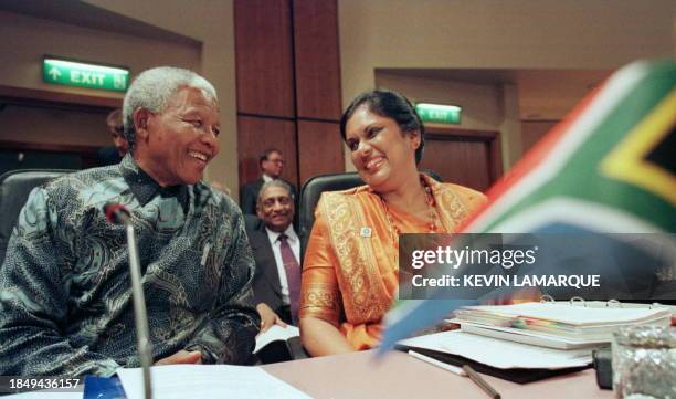 South African President Nelson Mandela and Sri Lankan President Chandrika Bandaranaike Kumaratunga laugh together before the first session of the...