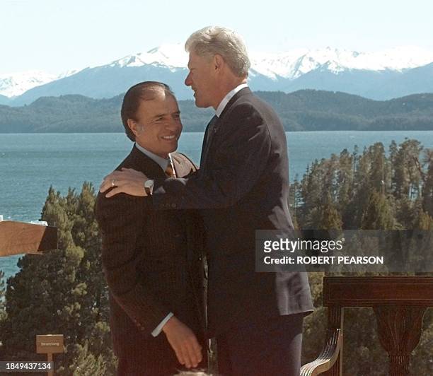 President Bill Clinton and Argentine President Carlos Menem talk 18 October in front of the Andes mountains in San Carlos de Bariloche, Argentina...