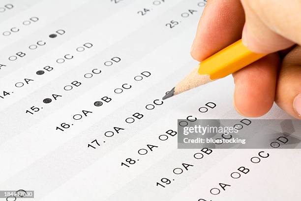 pencil held over a multiple choice exam - personality test stock pictures, royalty-free photos & images