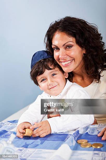 little boy with mother celebrating hanukkah - two young arabic children only indoor portrait stock pictures, royalty-free photos & images