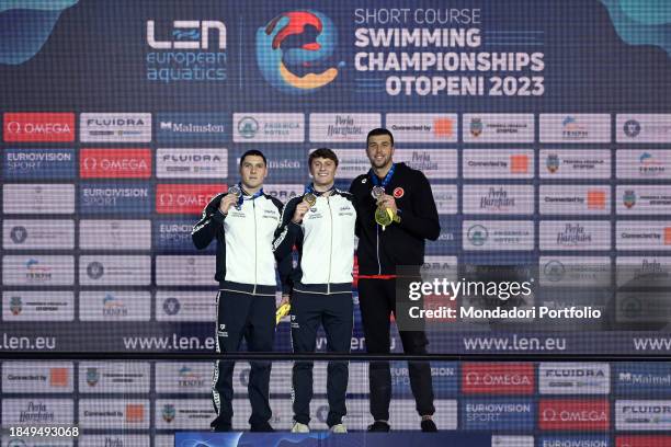 Simone Cerasuolo of Italy, silver, Nicolo Martinenghi of Italy, gold, Emre Sakci of Turkey, bronze show the medals after competing in the 50m...