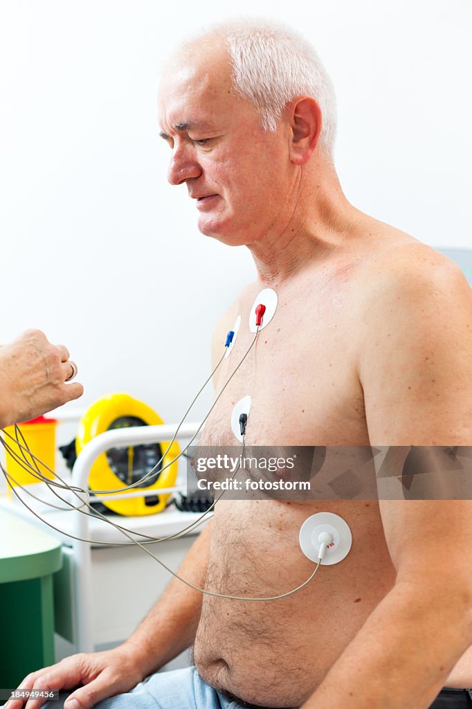 Nurse placing Holter monitor on patient's chest