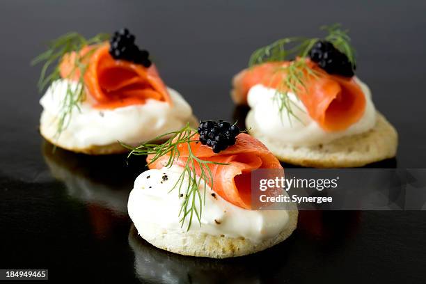 smoked salmon blinis - canapes stock pictures, royalty-free photos & images