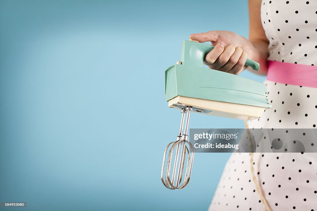 Woman holding vintage electric mixer