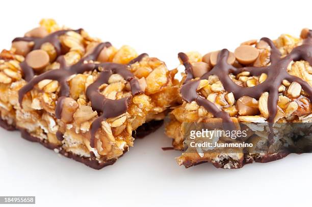 a tasty chocolate and peanut butter energy bar in half - nut butter stock pictures, royalty-free photos & images