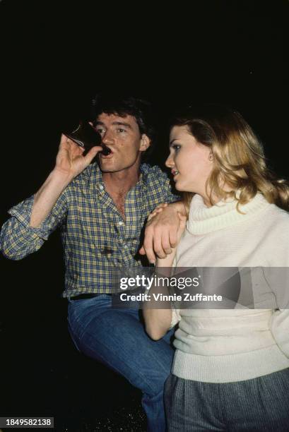 American actor Bryan Cranston, wearing a checked shirt and jeans, with American actress Jennifer Ashe, who wears a white turtleneck sweater and grey...