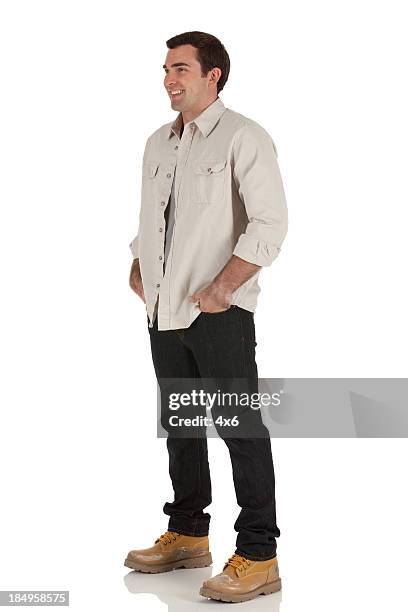 happy man standing with his hands in pockets - portrait white background looking away stock pictures, royalty-free photos & images