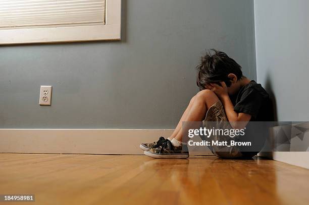 upset child - boy sitting on floor stock pictures, royalty-free photos & images