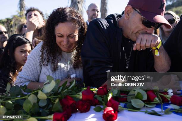 Family and friends mourn during the funeral of Eden Zachariya, who was abducted from the Tribe of Nova music festival on October 7, in Kibbutz...