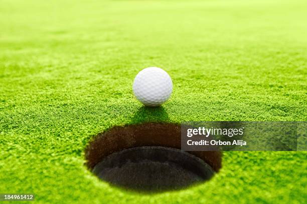 golf ball - golf ball hole stock pictures, royalty-free photos & images