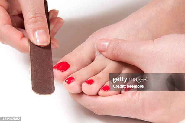 applying nail file on toe - hallux valgus stock pictures, royalty-free photos & images