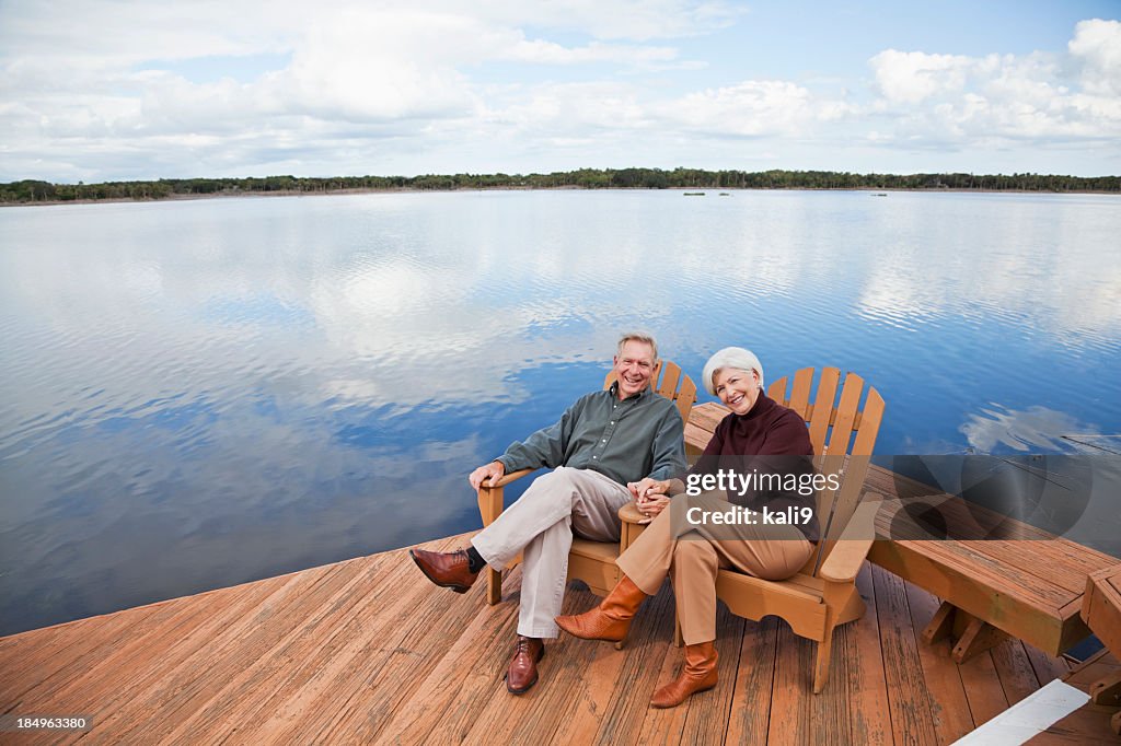 Senior couple sitting by water