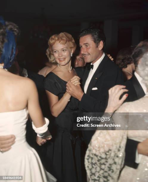 Errol Flynn dances with wife Patrice Wymore, circa 1950.