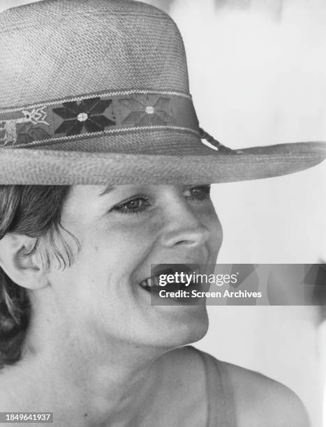 Candice Bergen smiling portrait in summer hat from 'The Domino Principle' 1977.