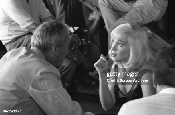 Marilyn Monroe and director John Huston discuss scene on the set of the 1961 film 'The Misfits'.