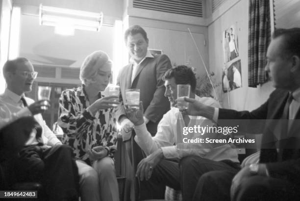 Marilyn Monroe , Dean Martin and Wally Cox drink a toast in dressing room on the set of the un-finished 1962 film 'Something's Got to Give'.